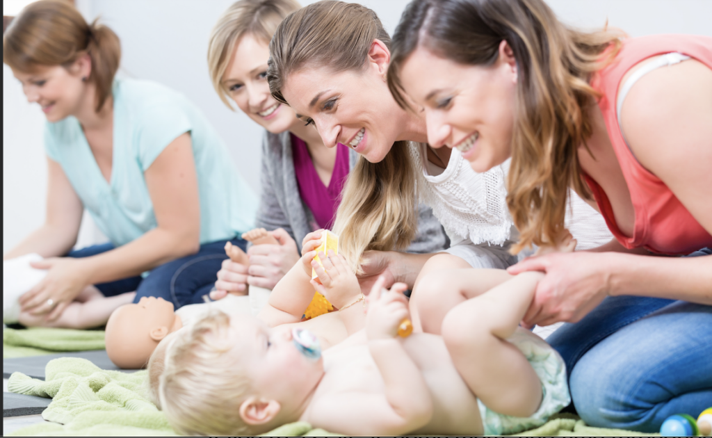 A group of moms with their babies at a Mommy & Me class.